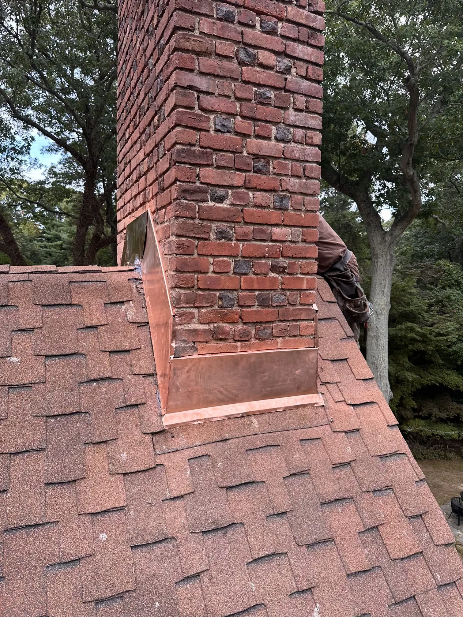 Chimney flashing replacement completed on residential roof to prevent water leaks