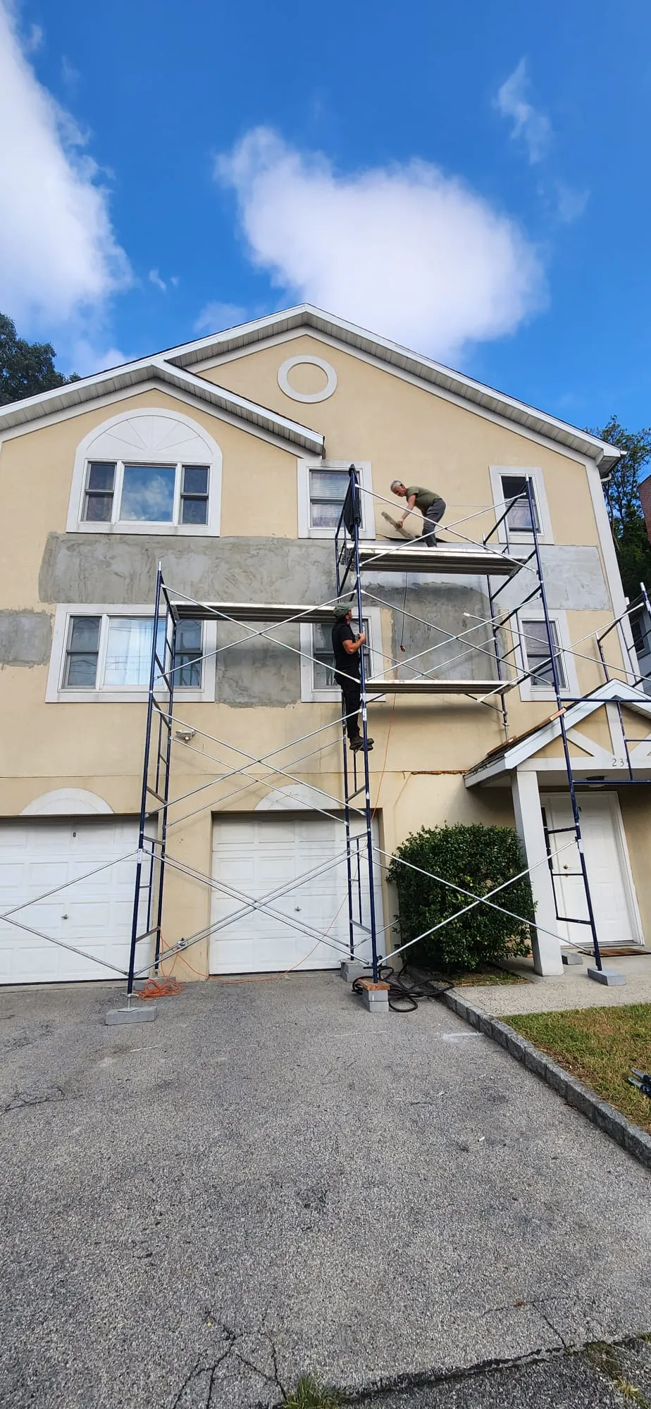 Stucco repair work restoring exterior surface